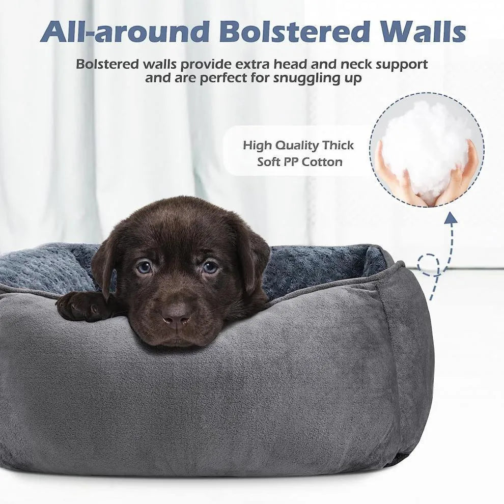 Beige bolster dog bed for large dogs with soft interior and raised sides on a wooden floor.