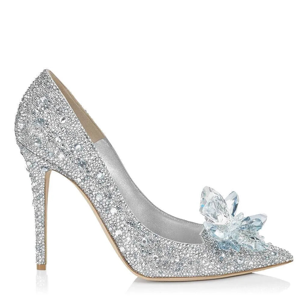 Women's gold stiletto high heel with pointed toe, rhinestone decorations, and a bow.