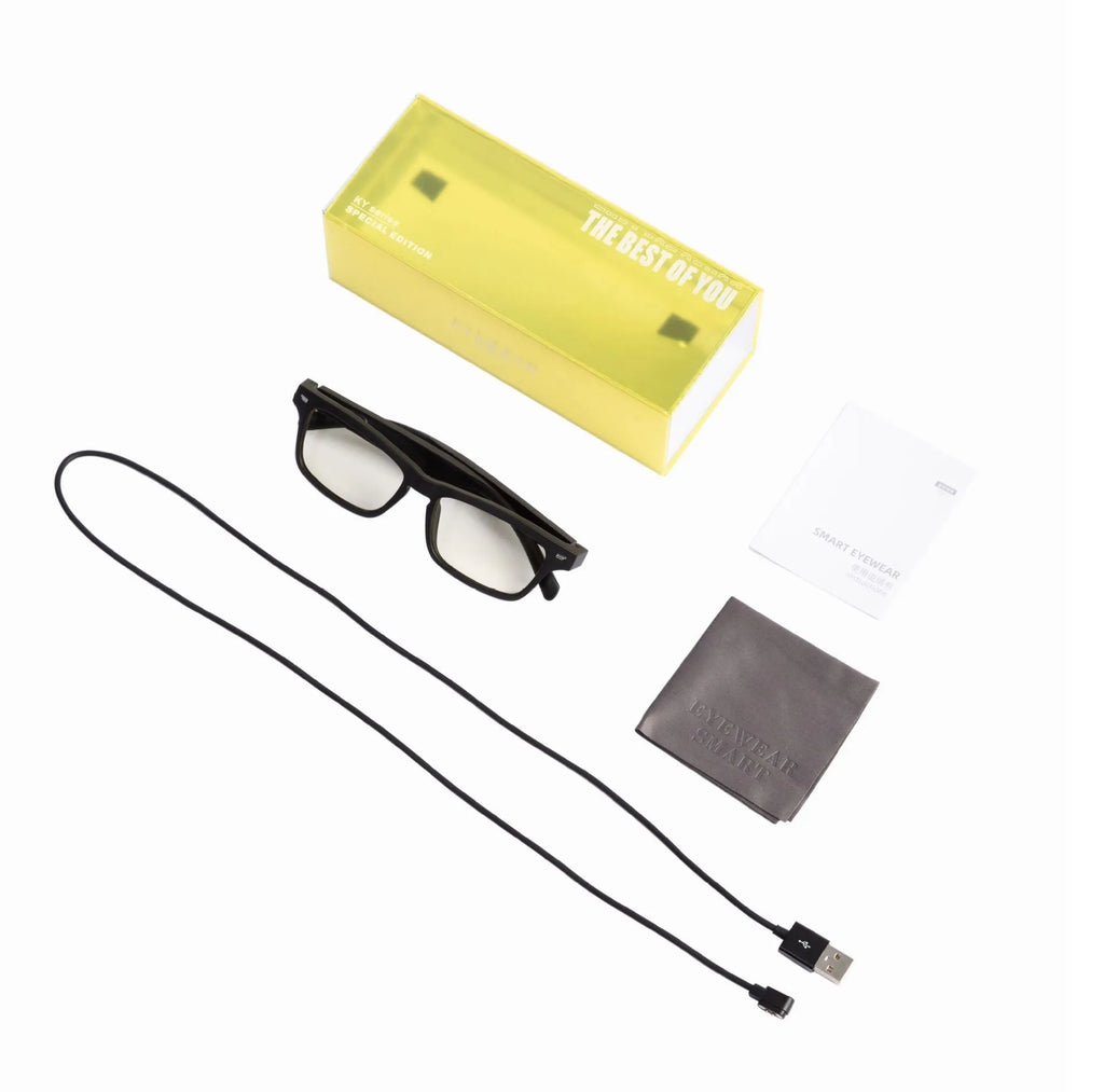 Smart sunglasses with open-ear Bluetooth speakers and polarised lenses on a table with charging case.