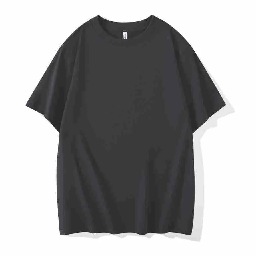 Man wearing a heavyweight dark grey drop shoulder T-shirt with layered shoulder detail.