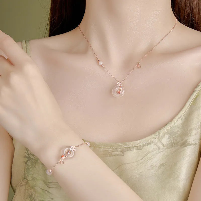 S925 sterling silver bracelet with white chalcedony beads and a gold-toned koi fish charm.