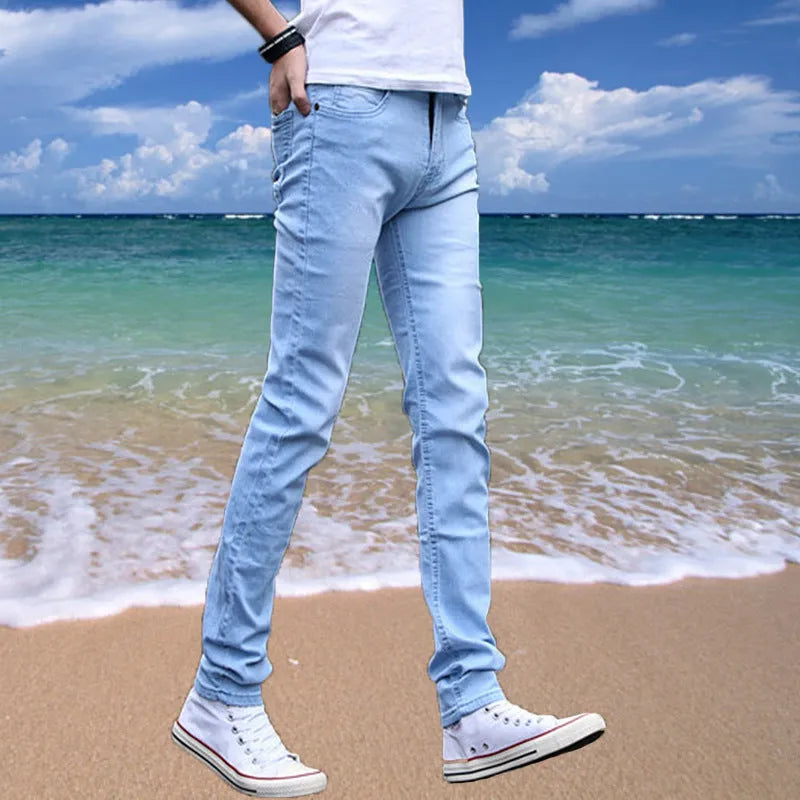 Thin men's loose skinny casual jeans in pure black with low waist, cropped leg, small leg opening, and zip fly.