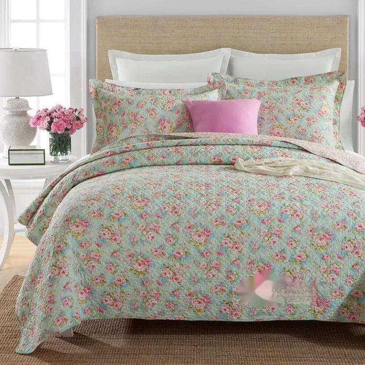 Quilted pure cotton bed cover set with printed pattern on a double bed with matching pillowcases.
