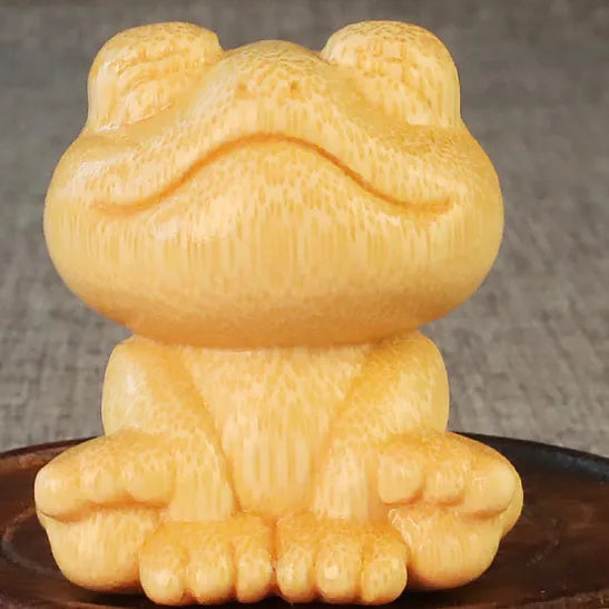 Solid bamboo smiling frog carving ornament measuring 5cm high with cartoon design