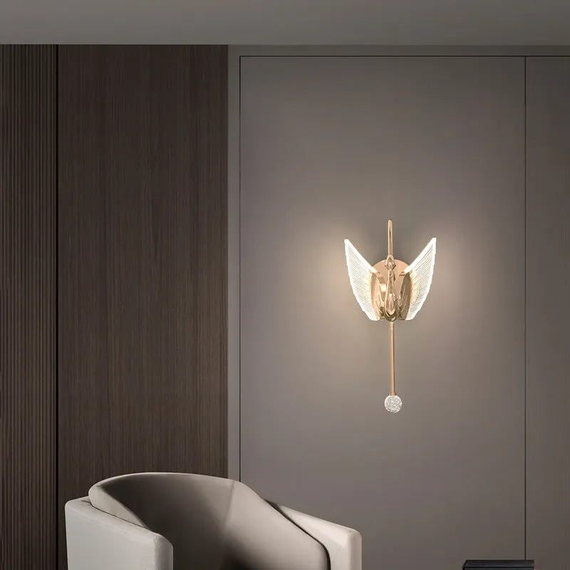 Gold modern swan-shaped wall lamp with an acrylic shade and dimmable LED light.