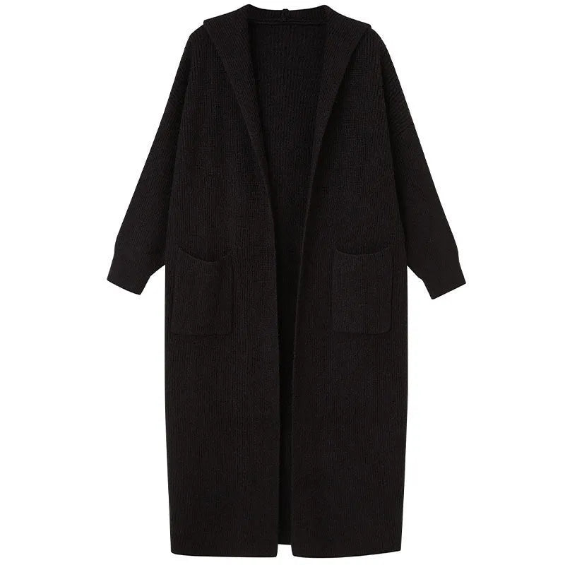 Long grey knitted hooded cardigan coat with long sleeves on a hanger.