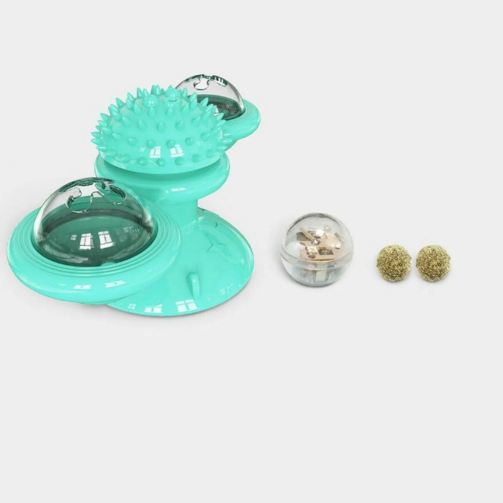 Rotating windmill cat toy with LED light and catnip balls on a white wall