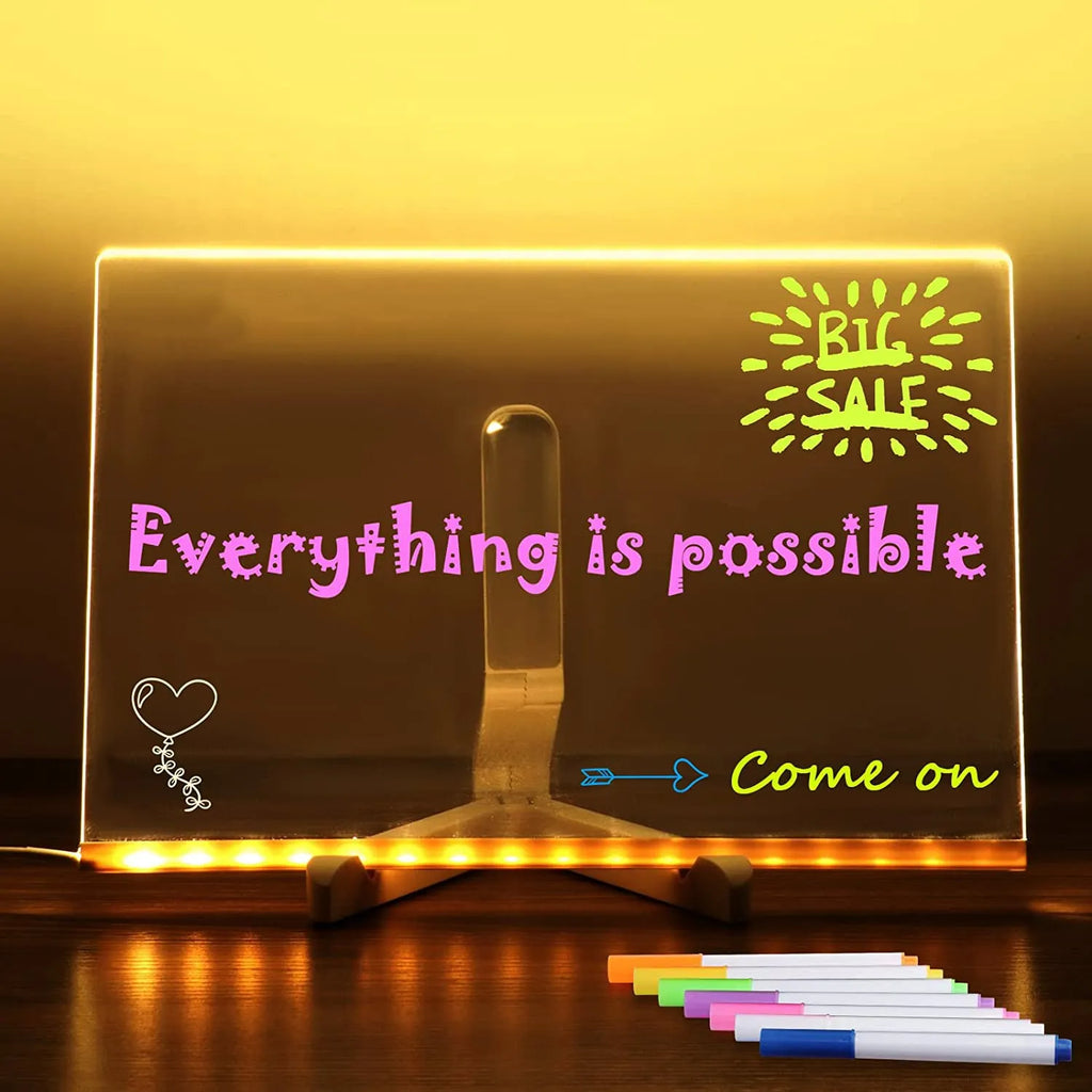 Acrylic LED message board night light on a desk with colourful handwritten notes glowing softly.