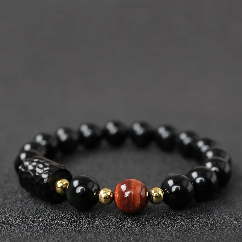 Obsidian bracelet with yellow tiger eye beads showing retro circular design