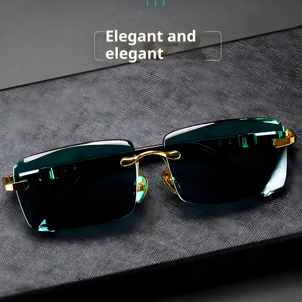Dark green frameless crystal sunglasses with a hard case and cleaning cloth on a plain background.