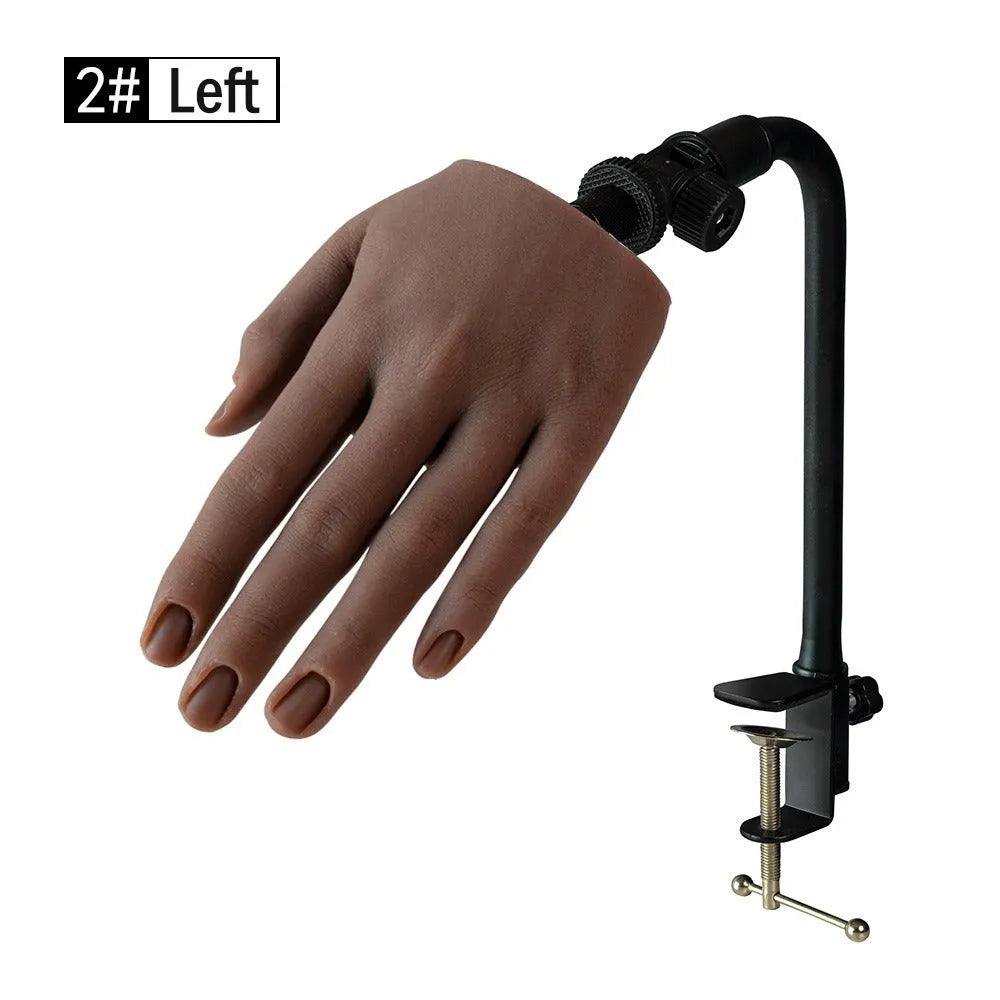 Silicone nail art practice hand model with movable fingers on a table.