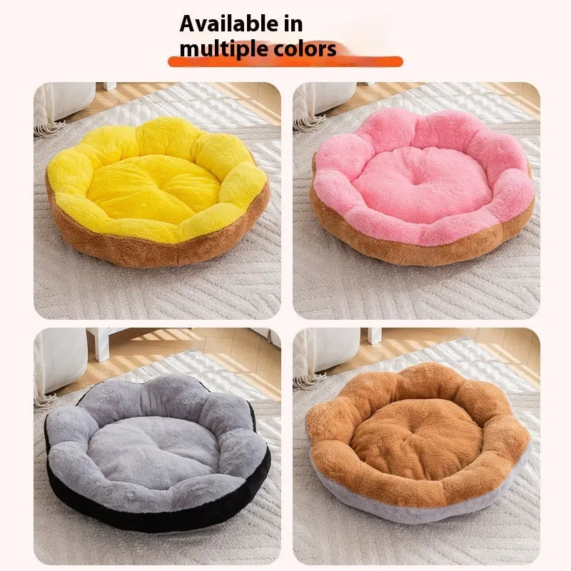 A thick grey and black plush round cat bed nest with raised sides on a wooden floor.