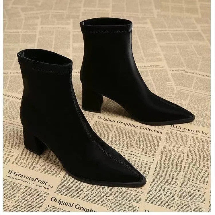 Women's khaki pointed-toe Martin boots with a wedge heel on a plain background.