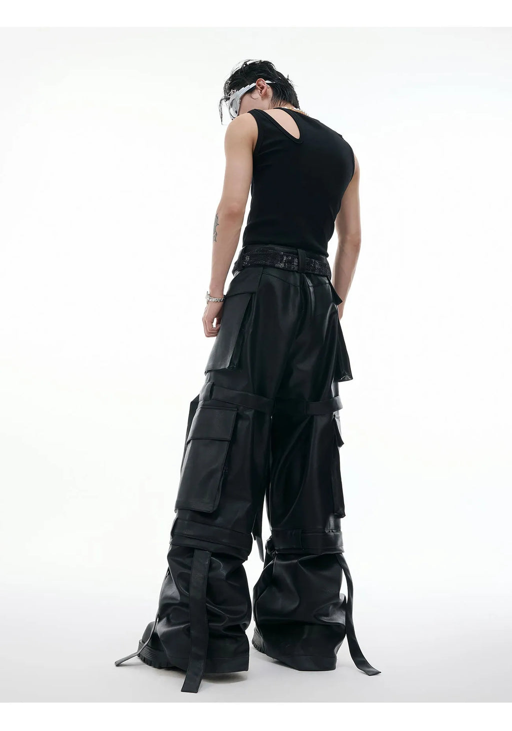Black quilted leather pants with multiple pockets and decorative stitching ribbon details