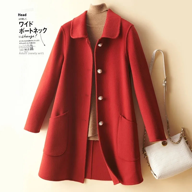 Women's mid-length wool coat with pearl buckle fastening and doll collar in solid colour