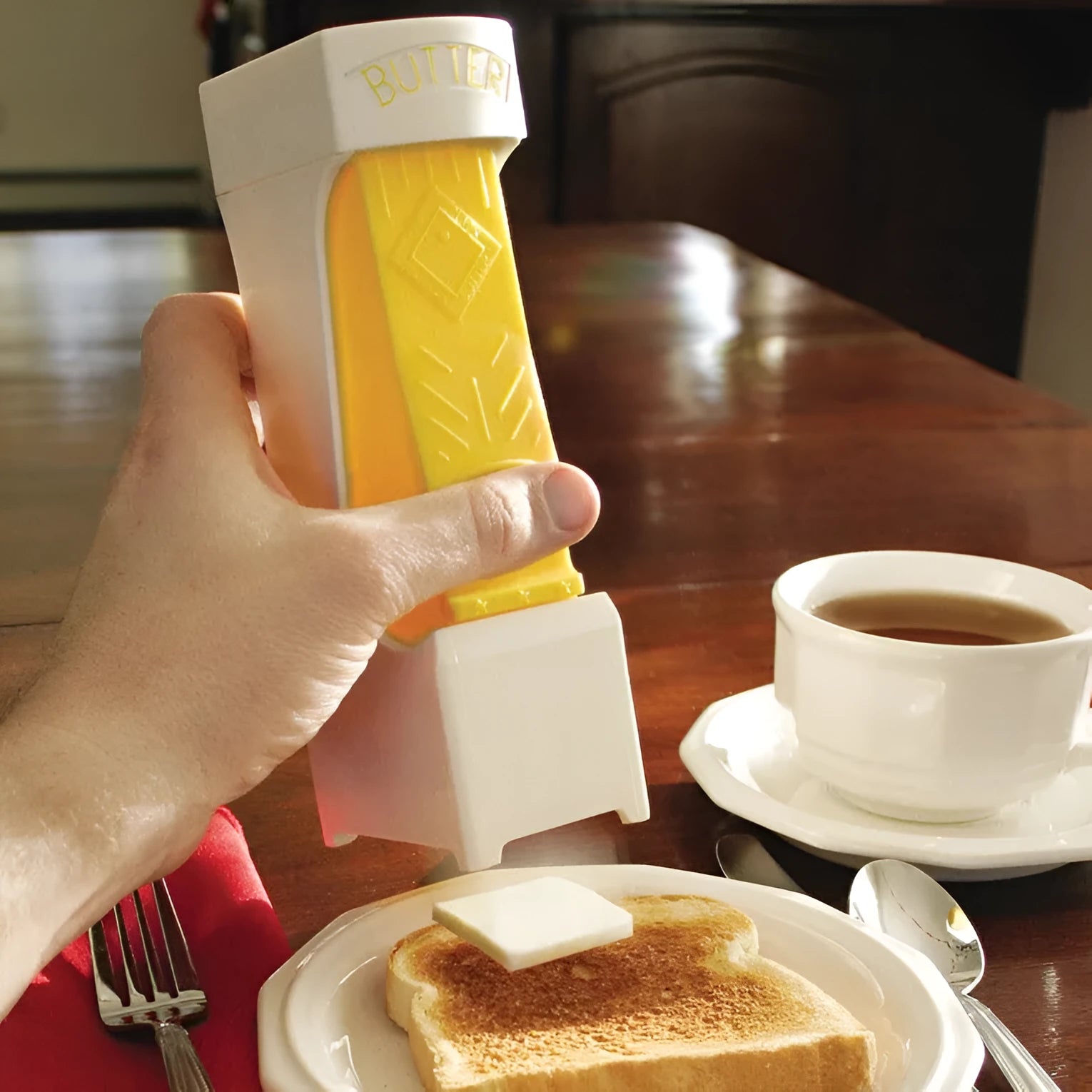 Yellow plastic butter cutter with stainless steel blade for quarter-pound butter bars