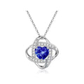 Close-up of a ladies heart-shaped love necklace pendant in a platinum colour finish on a model.