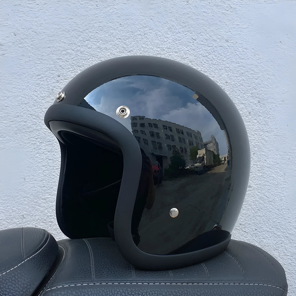 Retro-style glass fibre half motorcycle helmet shown in a selection of colours and prints.
