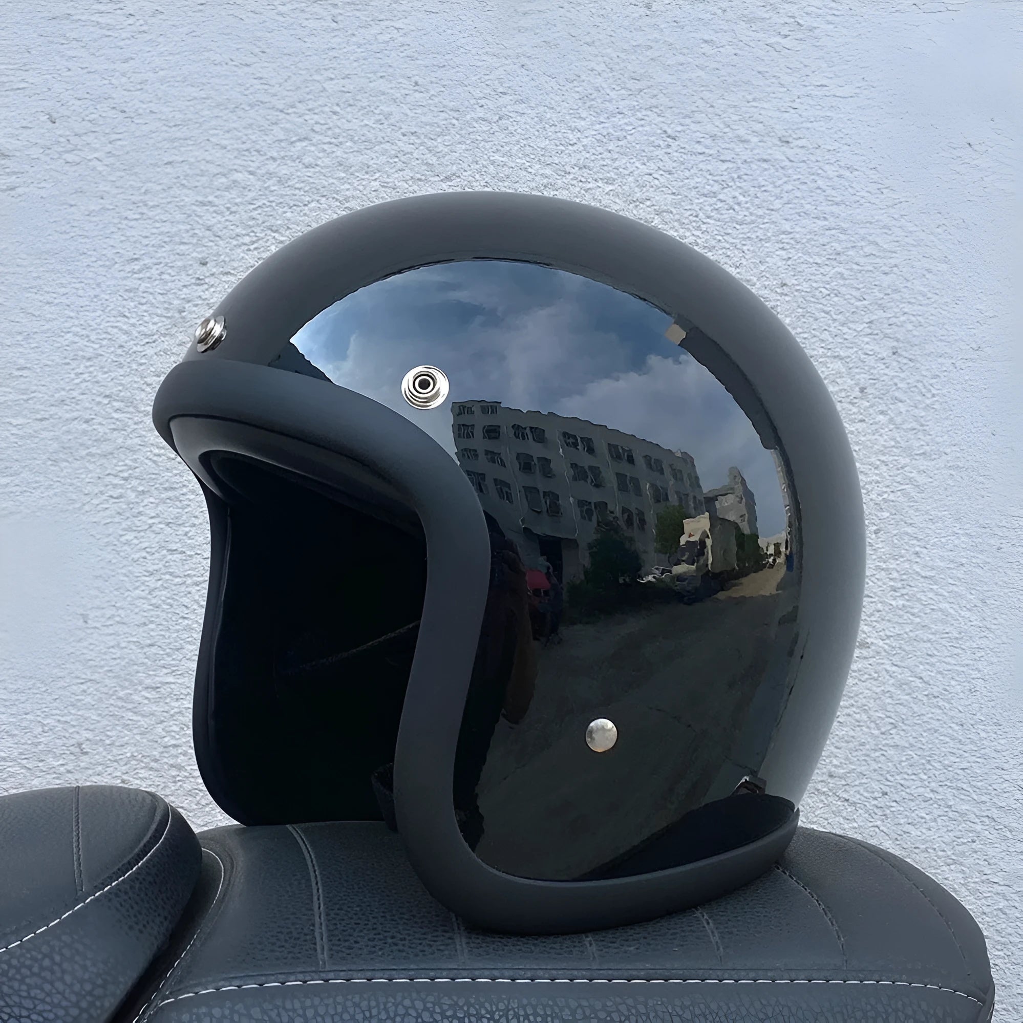 Retro-style glass fibre half motorcycle helmet shown in a selection of colours and prints.