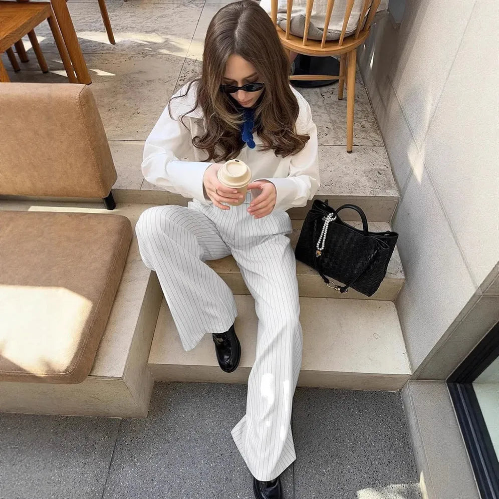 White striped loose fit wide-leg casual trousers with a zipper, shown on a hanger.