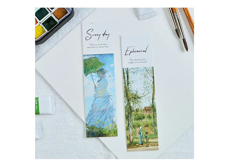 Pack of 30 white cardboard art bookmarks with designs including flowers and patterns, next to their plastic carton.