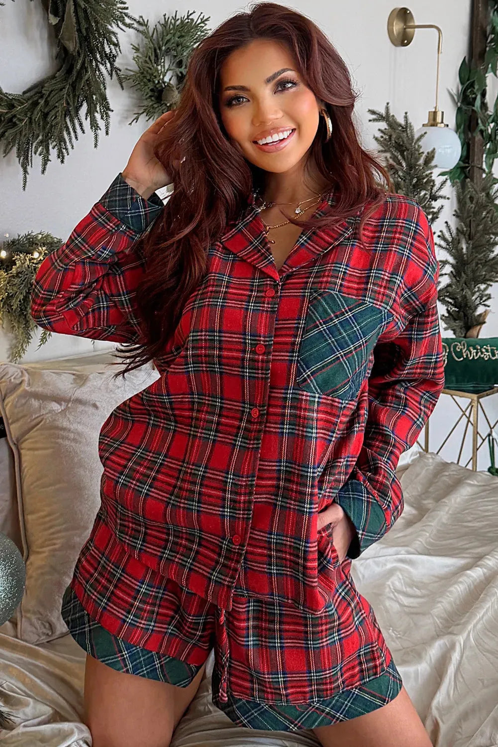 Red plaid long sleeve pyjama shirt and matching shorts set on a white background.