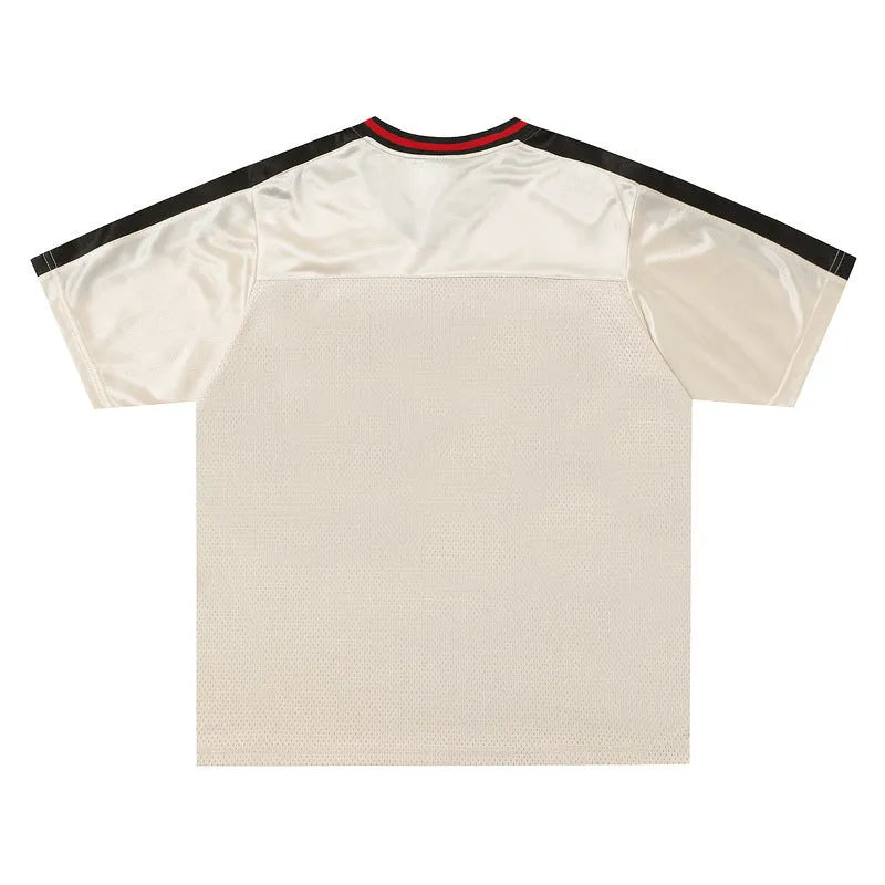 Apricot coloured loose fit sports V-neck jersey with short sleeves and a letter pattern.