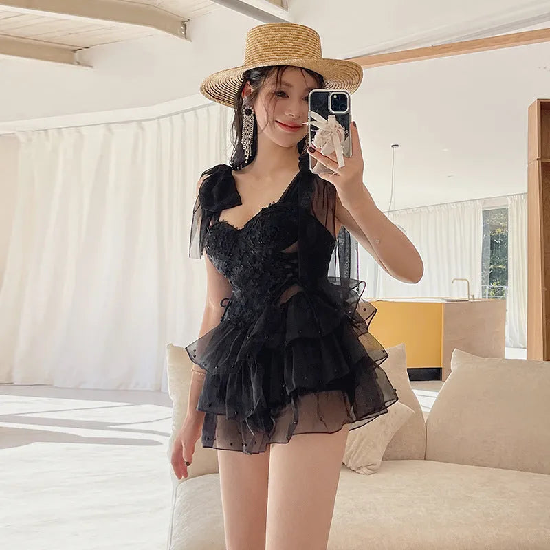 Black conservative one-piece swimsuit with chest gathered design and sleeveless styling
