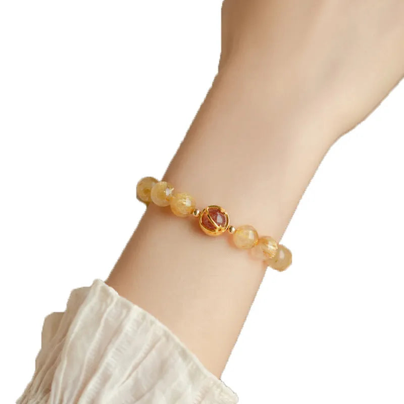 Gold rutilated quartz crystal bracelet with diamond-cut beads in 6mm and 8mm size options.