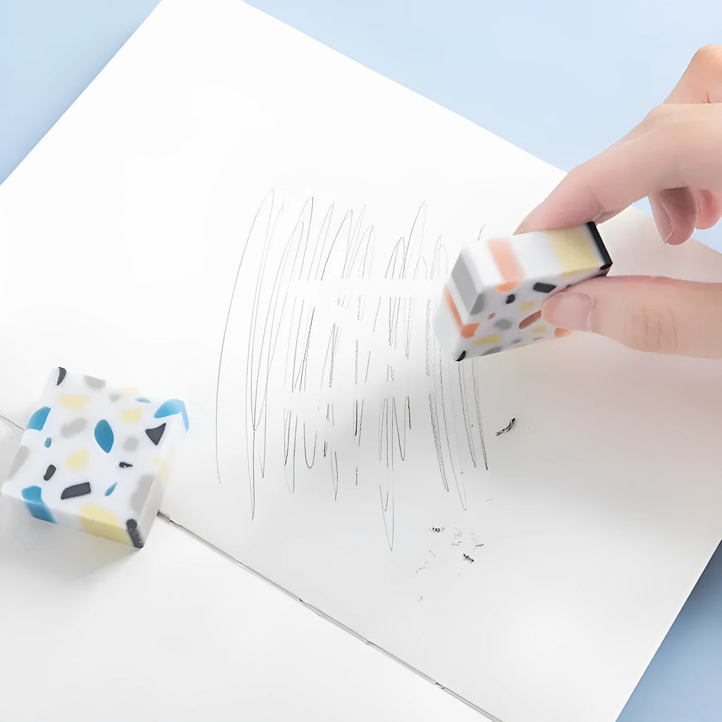 Small white PVC art eraser on a blue background showing its 36mm size.