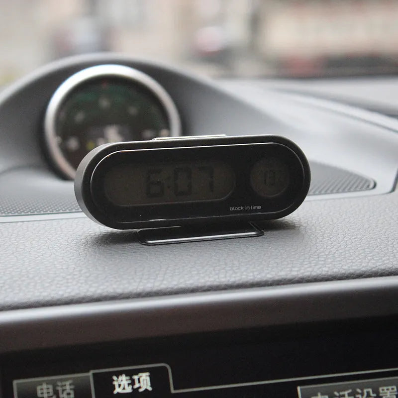 Black car digital clock and thermometer with LED display on adjustable bracket.
