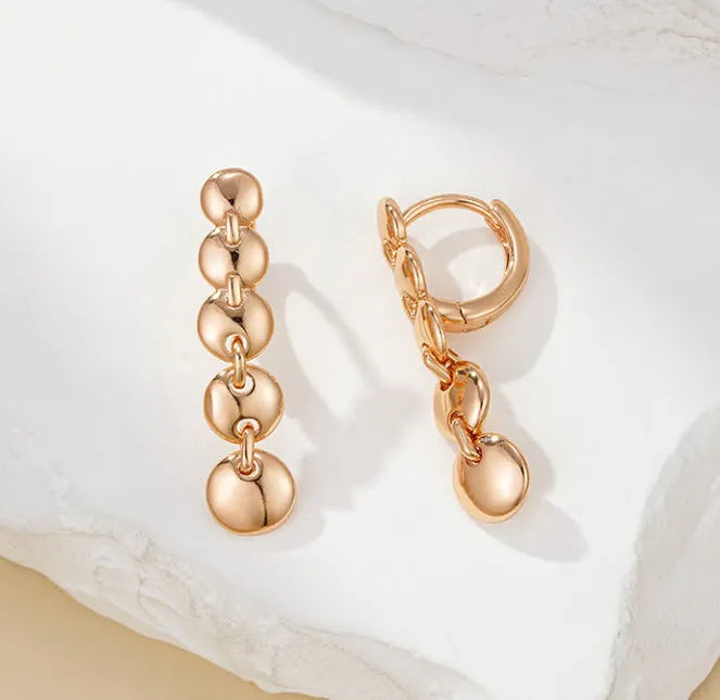 A pair of gold retro woven copper large circle hoop earrings.