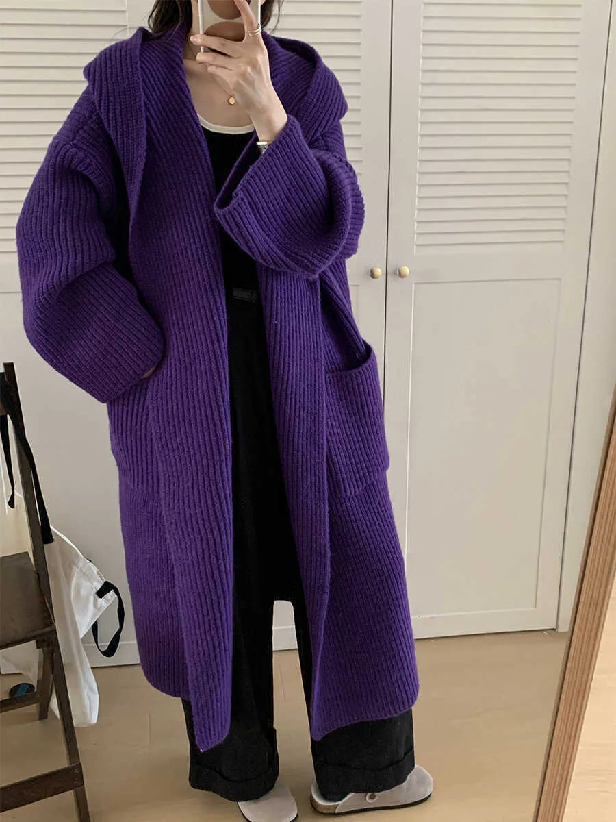 Women's milky white loose hooded cardigan coat with long raglan sleeves on a hanger.