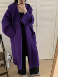 Women's milky white loose hooded cardigan coat with long raglan sleeves on a hanger.