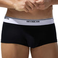 Men's solid colour cotton boxer shorts on a plain background, showing low waist design.