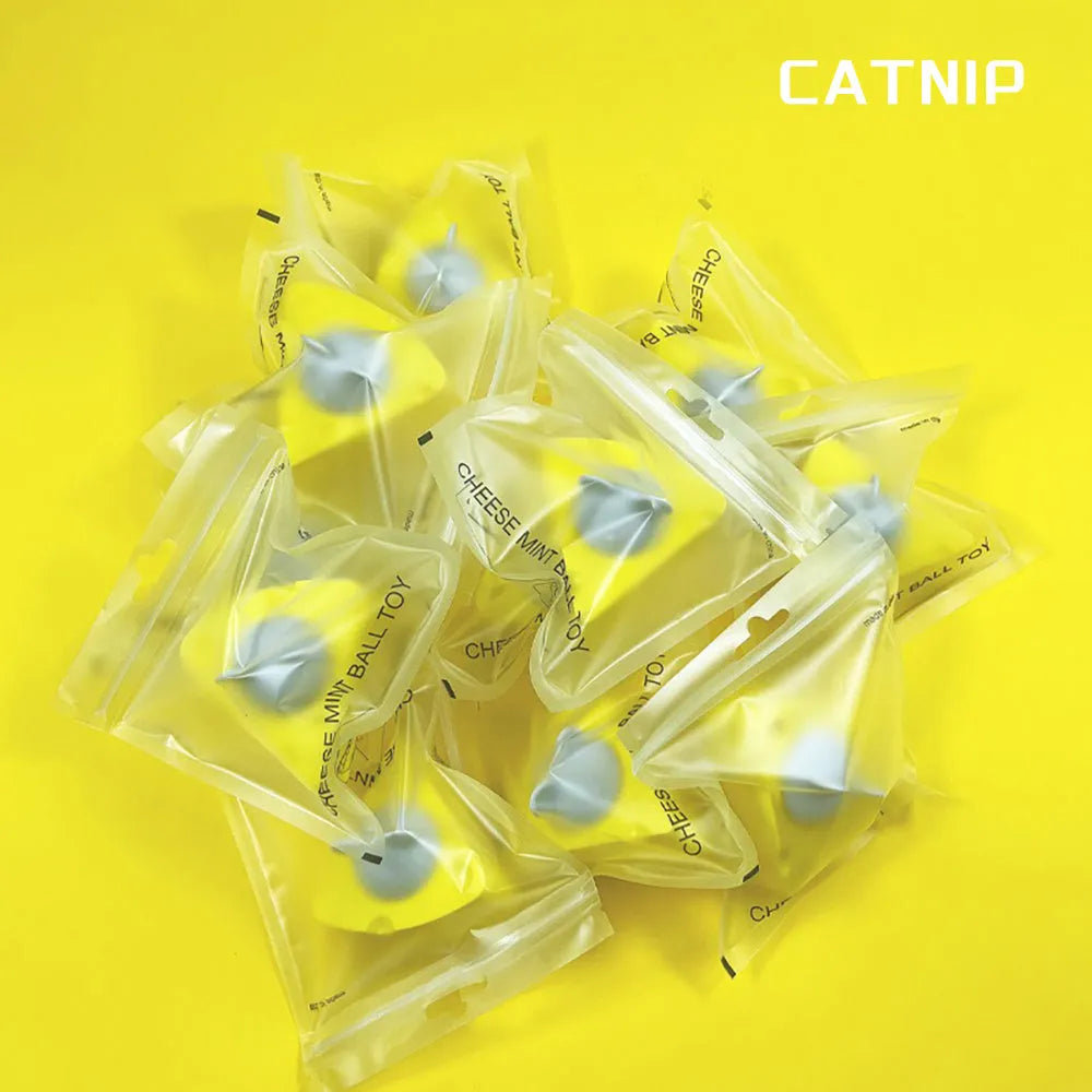 Yellow catnip and silvervine chew toy balls for cats on a plain background.