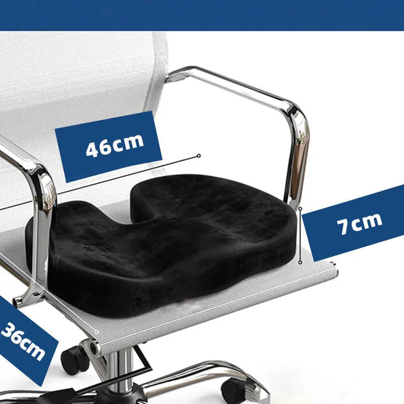 Black U-shaped memory foam seat cushion for office chairs, shown on a wooden seat.