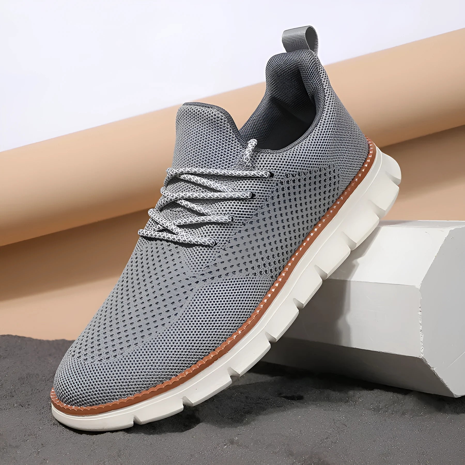 Men's grey and black low-top casual sneakers with woven mesh fabric upper and round toe.