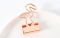 Small gold metal office clip with long tail, showing flamingo, love, cloud, cat, cactus, and bow shape options.