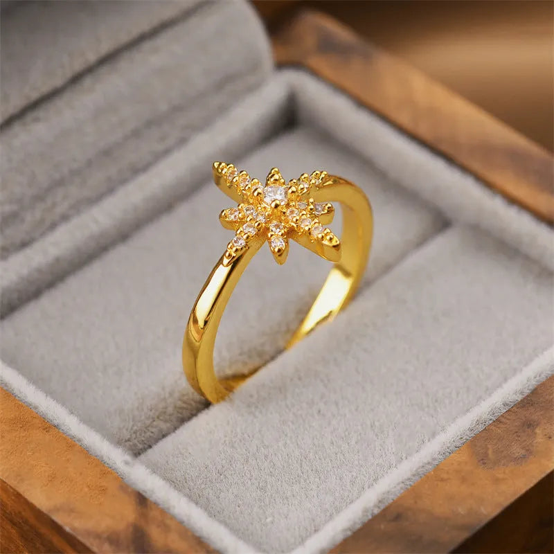 Gold open geometric women's fashion ring on a neutral background.
