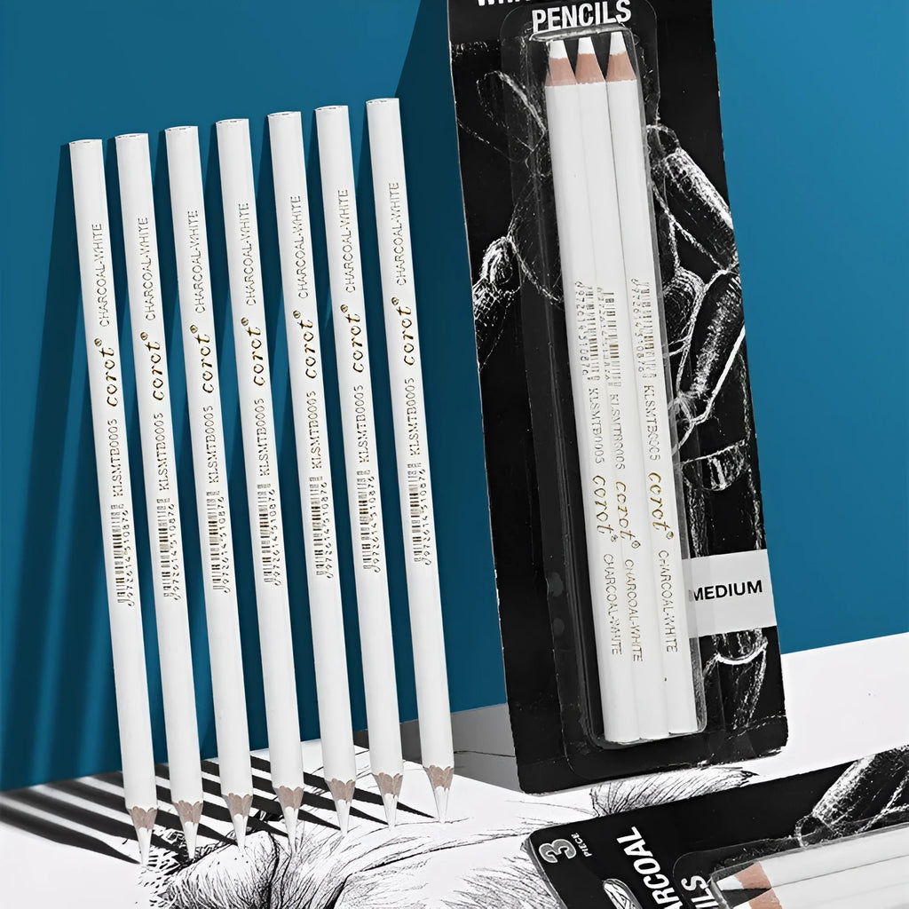 Three white charcoal sketching pencils with wooden shells on a dark surface.