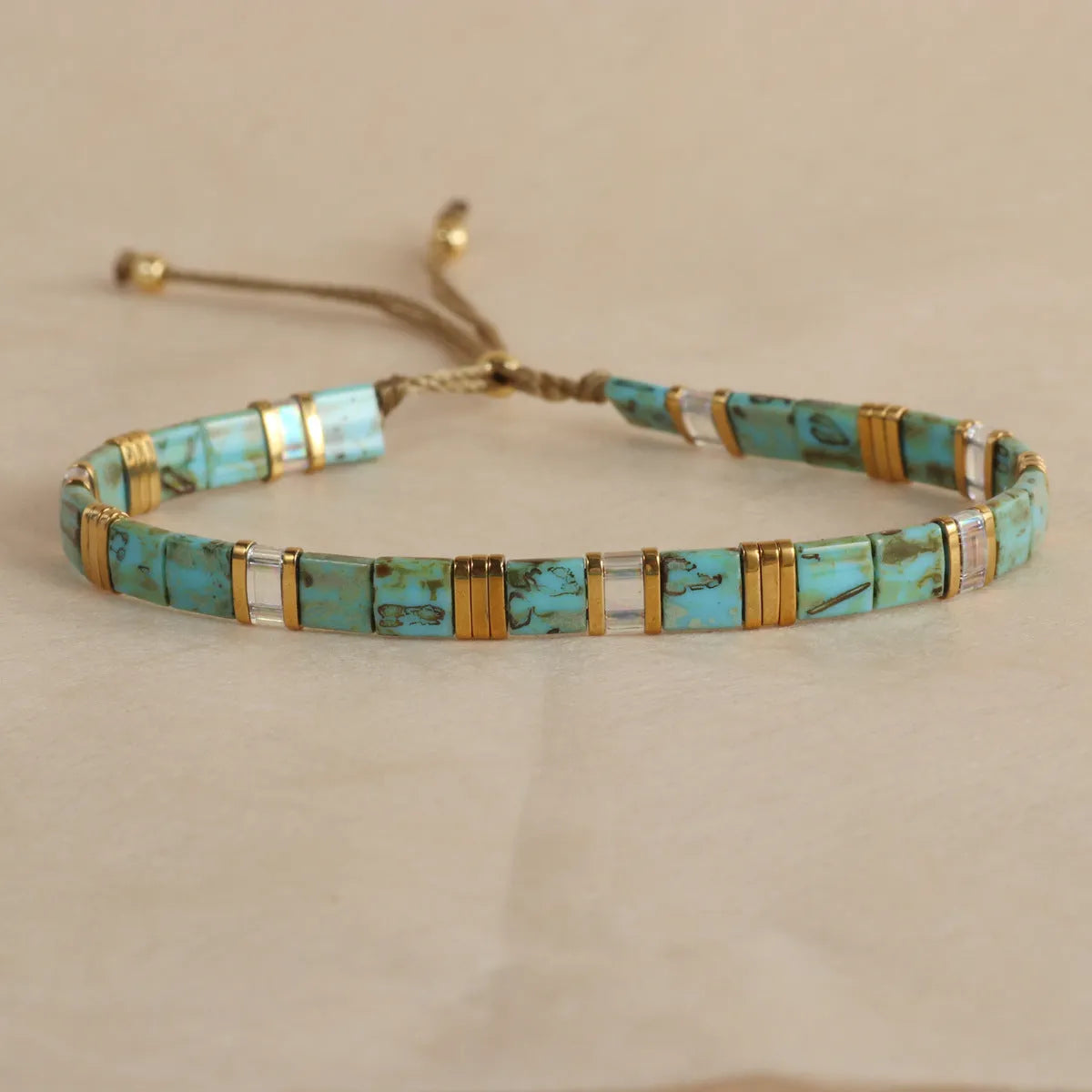 Geometric pull bead bracelet with glass and coloured glaze beads in round design