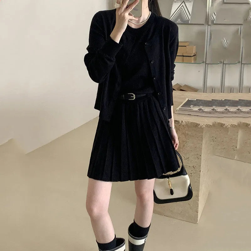 Women's black art retro knitted two-piece set with long-sleeve cardigan, pleated vest skirt, and a belt.