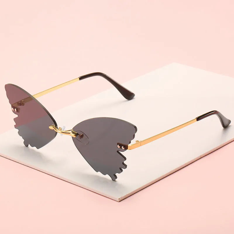 Butterfly rimless sunglasses with UV400 protection, vintage style, plastic and metal frame, available in blue green grey pink purple red yellow