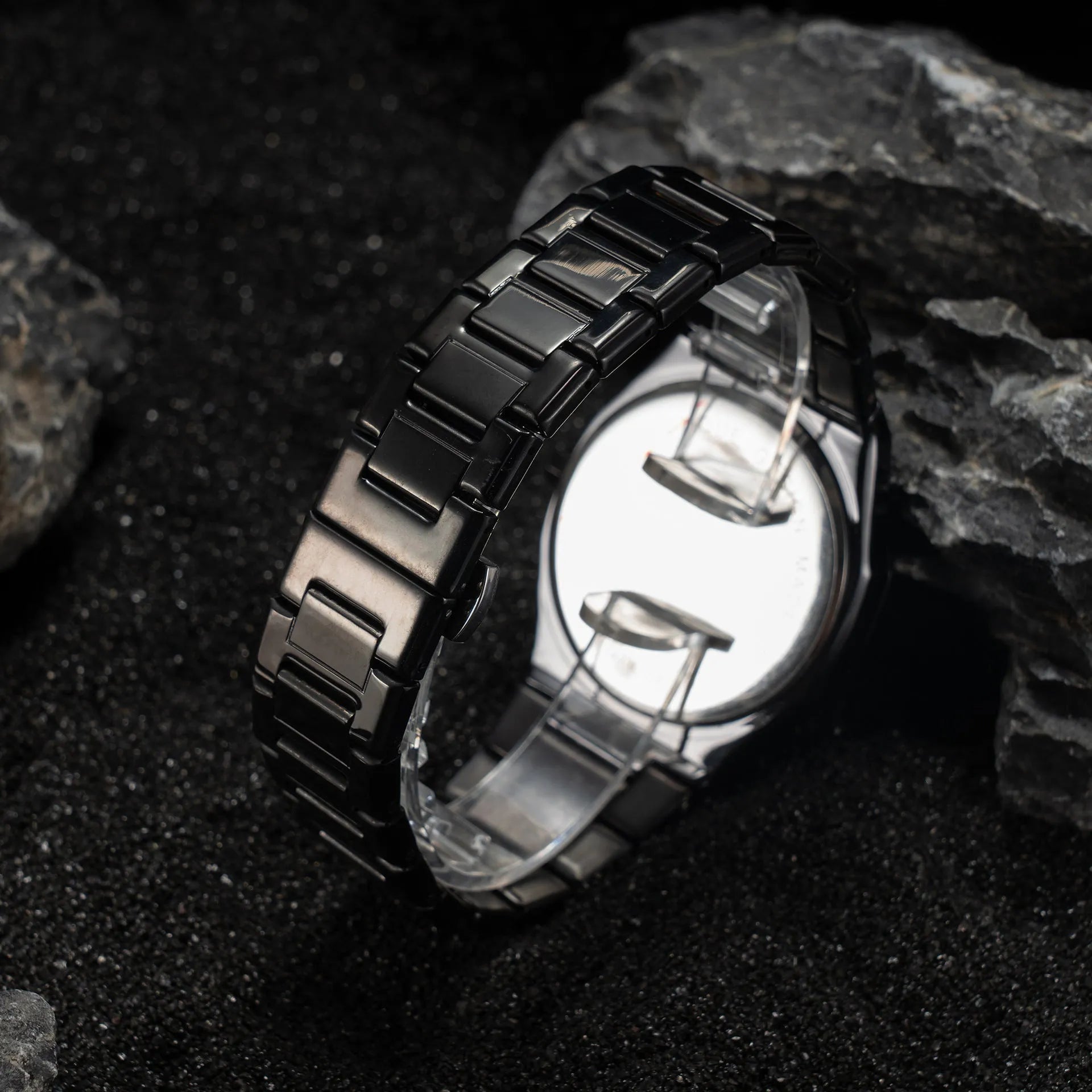 Men's silver and black business casual watch with steel bracelet and analogue dial on a wrist.