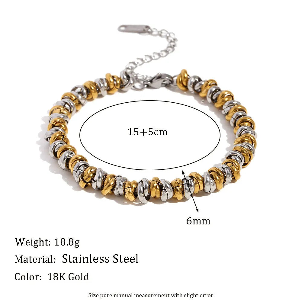 Gold geometric stainless steel jewellery set for women, including earrings, bracelet, and necklace.
