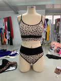 White and leopard print women's high-waist bikini swimsuit set on a mannequin.