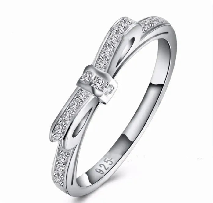 Silver bow-shaped ring with zircon rhinestone crystals on electroplated band