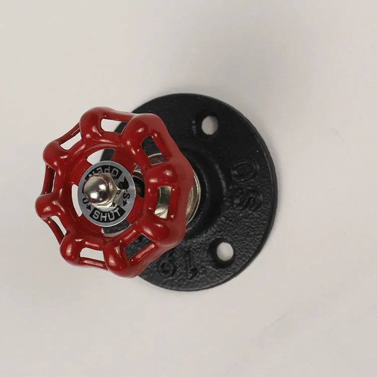 Water pipe style metal wall hook for towels on a white wall, shown in black, green, and red colour options.