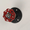 Water pipe style metal wall hook for towels on a white wall, shown in black, green, and red colour options.